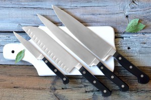 38779071 - set of kitchen knives on a board, top view